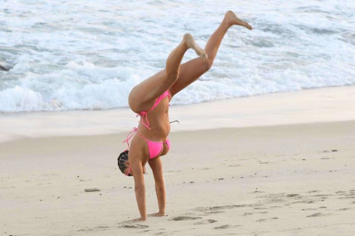 Kim Kardashian Wet In A Pink Bikini For A KKW Beauty Photoshoot